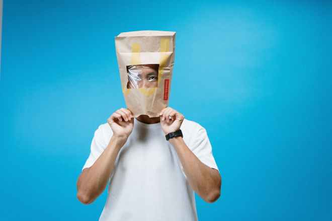 man wearing paper bag on head